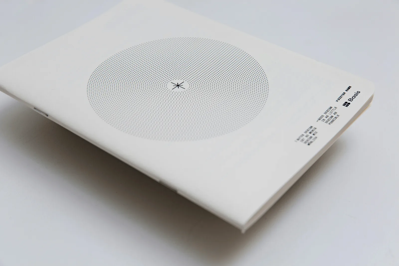 Basis brand book: a cream cover with a halftone dot circle, an asterisk mark, and a printed Dieter Rams quote