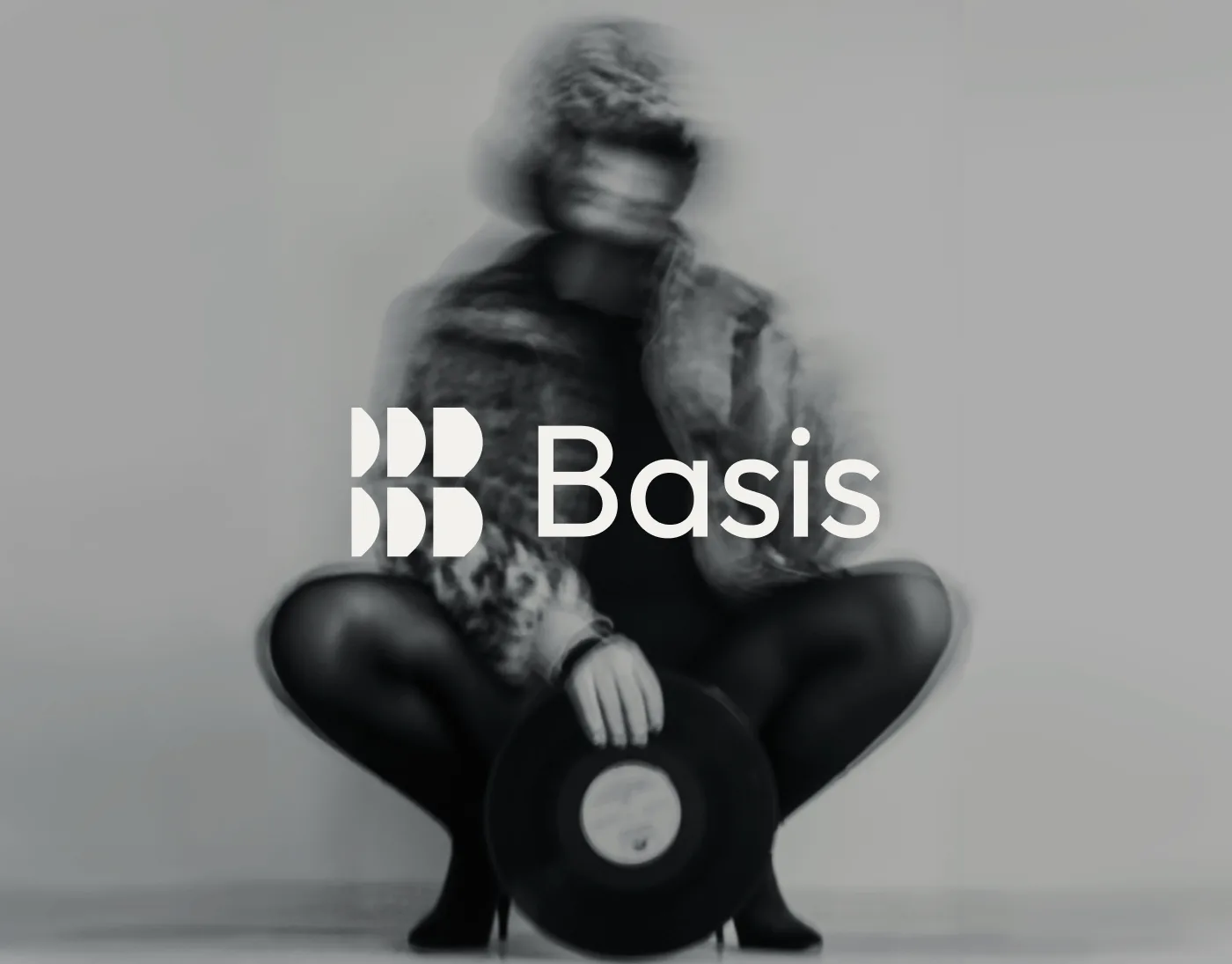 Basis case study hero: the Basis mark and wordmark over a monochrome photograph of a figure crouching with a vinyl record