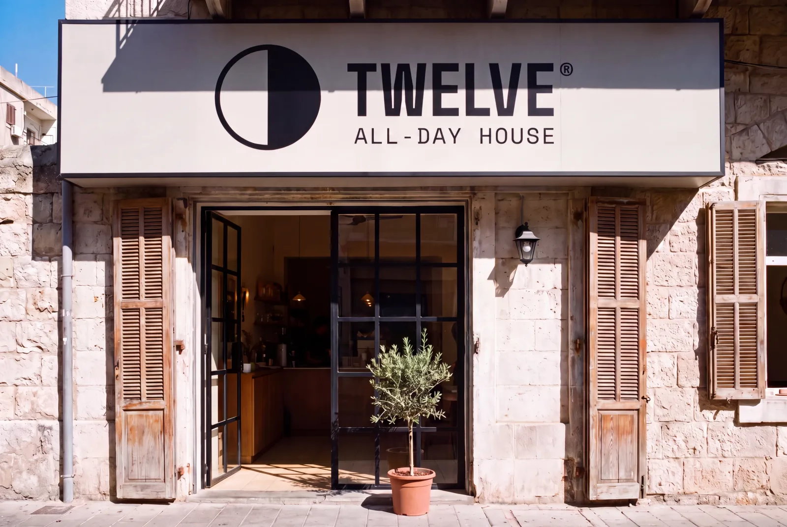 The TWELVE fascia sign over a stone shopfront in Mar Mikhael, Beirut, in hard midday sun