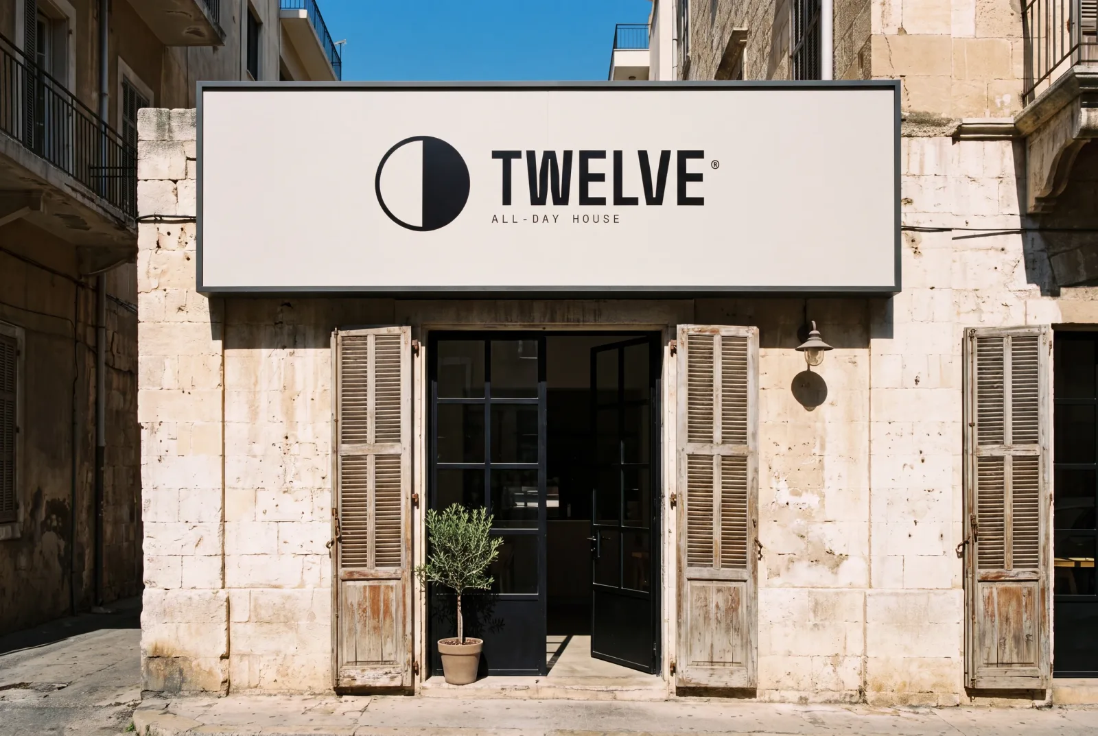 The TWELVE fascia sign over a stone shopfront in Mar Mikhael, Beirut, in hard midday sun